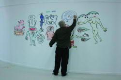 Daniel drawing on wall in gallery